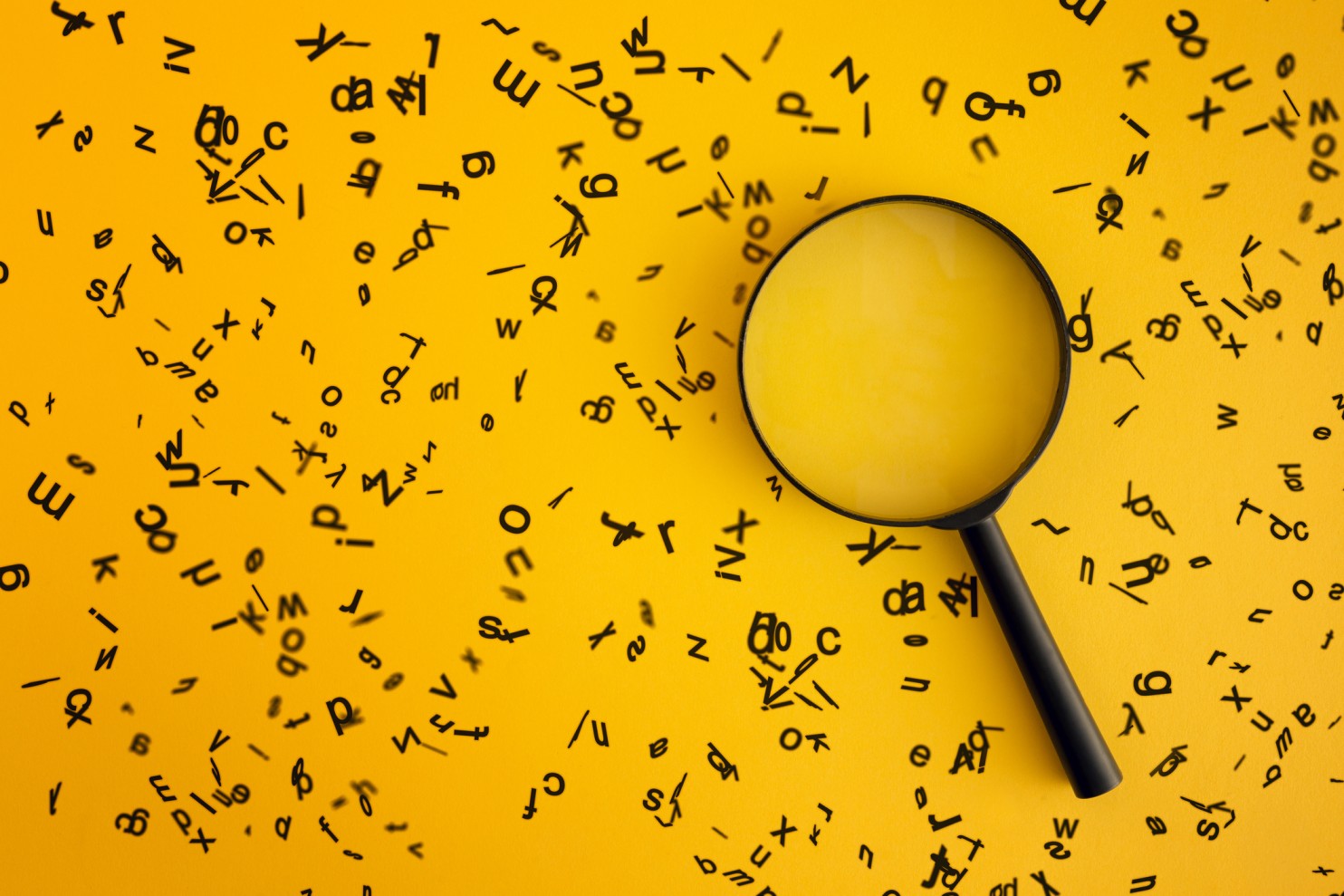magnifying glass with random letters representing SEO